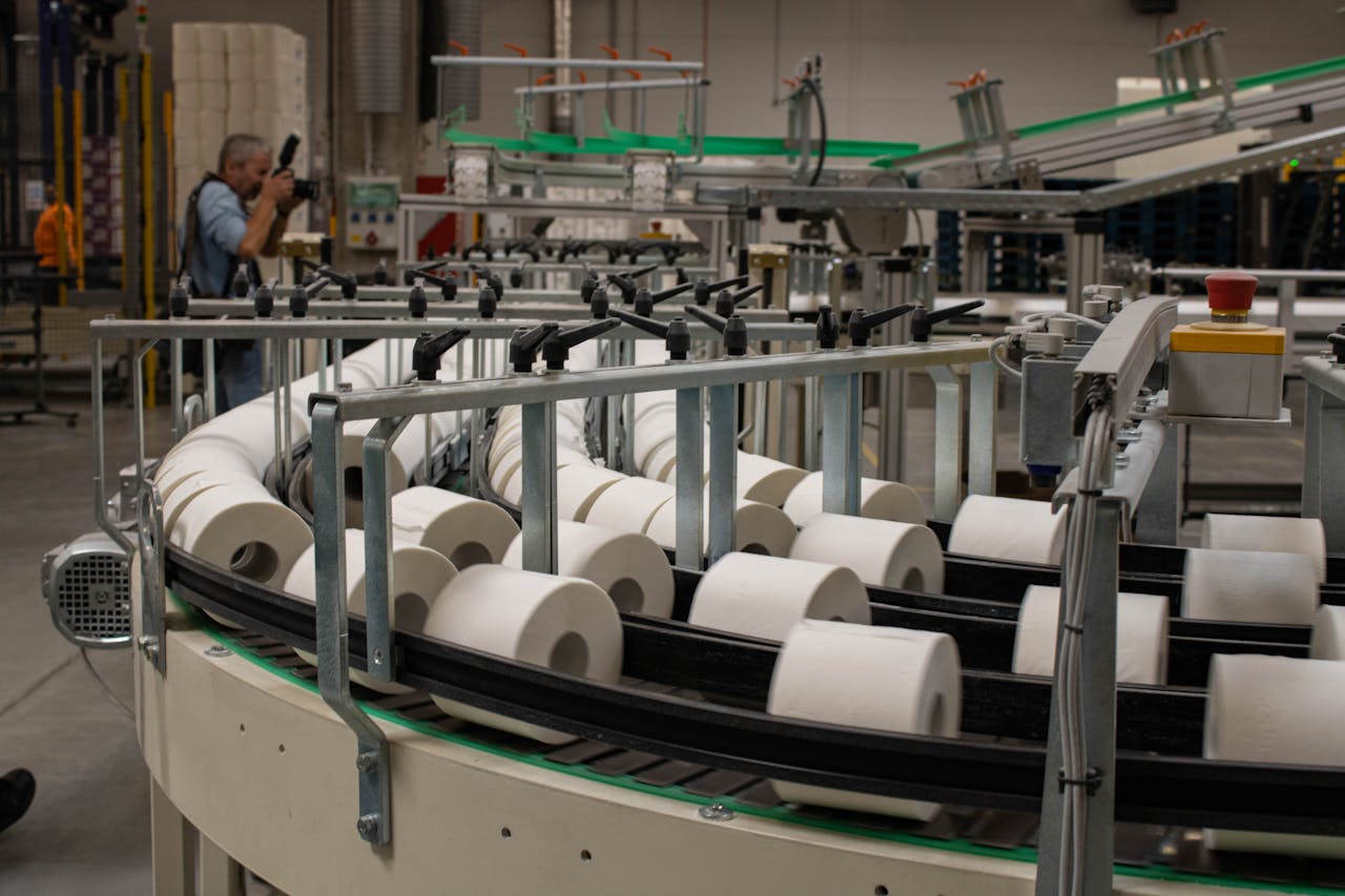 Photographer captures a production line for toilet paper in an industrial setting.